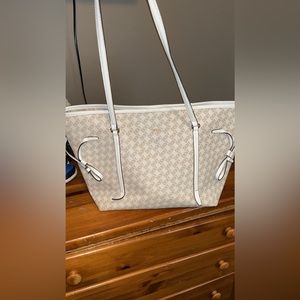 DKNY medium purse. It is white with cream DKNY written on it.